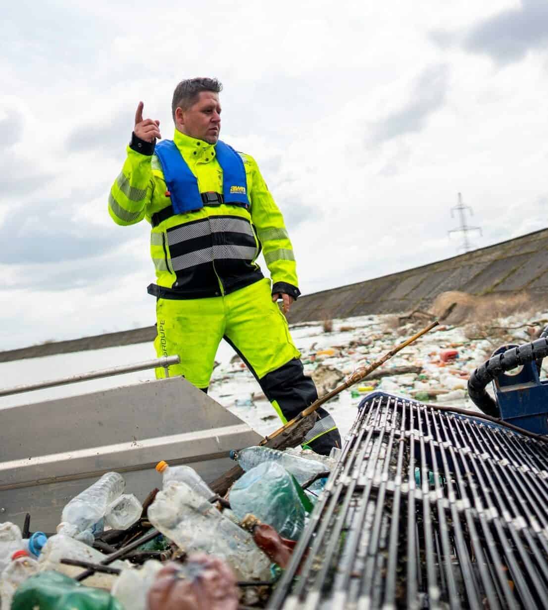 Boat operator directs Garbage Boat while Cleanup Mission in Romania
