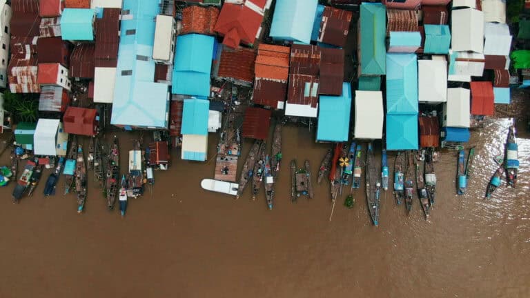 River from Above with corrugated iron houses and Boats - BBC StoryWorks