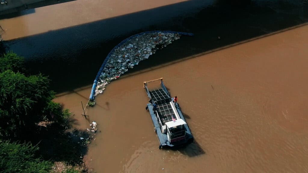 Garbage Collection Boat collecting waste out of a River - BBC StoryWorks